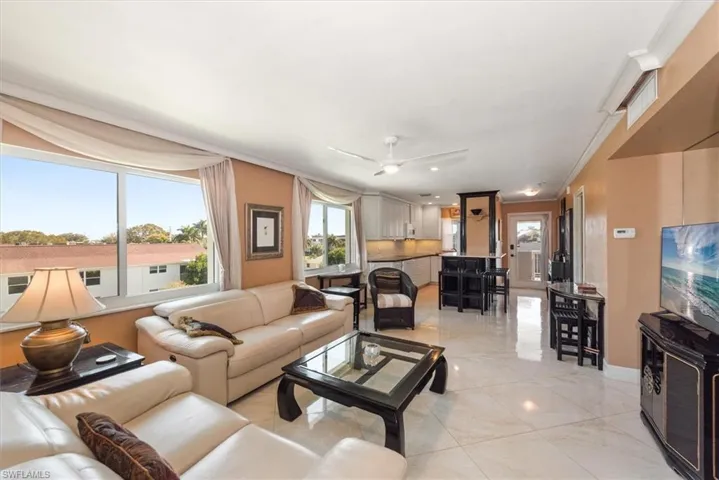 Living room with a ceiling fan and tons of windows