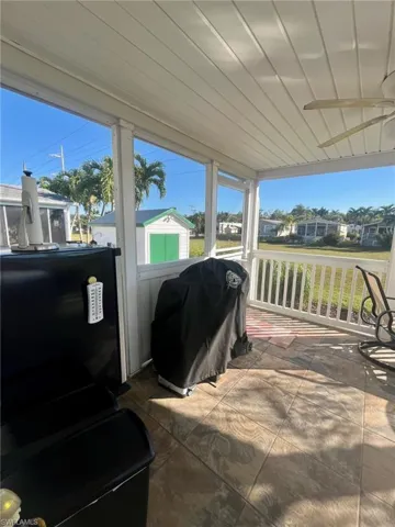 View of patio / terrace with a grill, a shed, and a residential view
