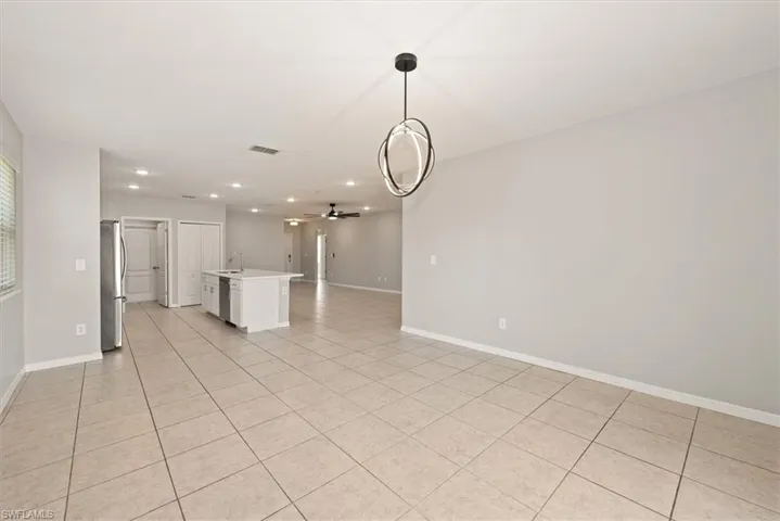 Unfurnished living room with recessed lighting, ceiling fan, and light tile patterned floors