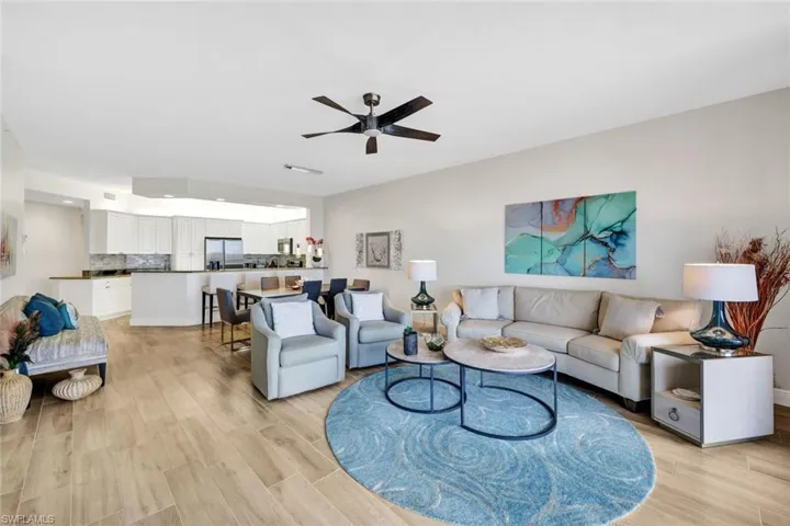 Living room with ceiling fan and light wood-type flooring