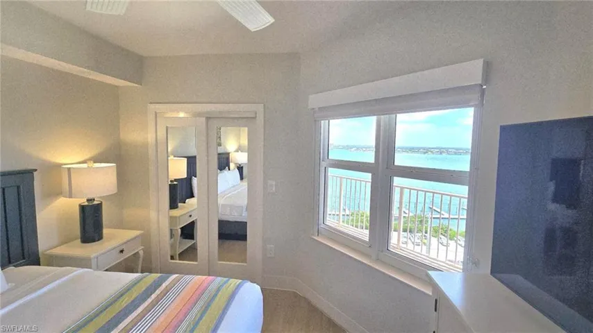Bedroom featuring a water view and wood finished floors
