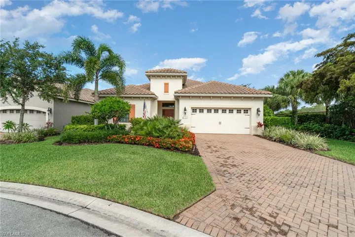 Mediterranean style home with a front yard and a garage