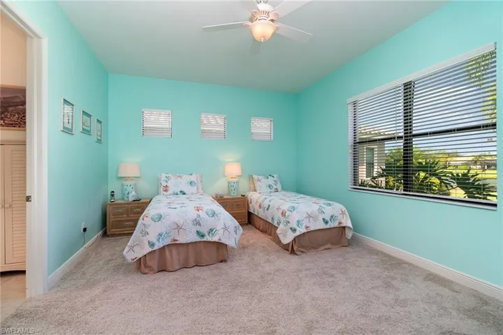 Carpeted bedroom with ceiling fan