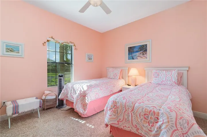 Carpeted bedroom featuring ceiling fan