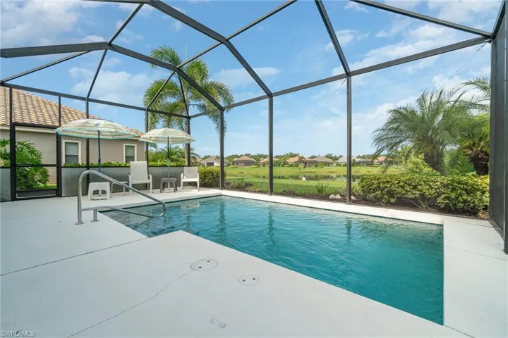 View of swimming pool with a lanai and a patio area