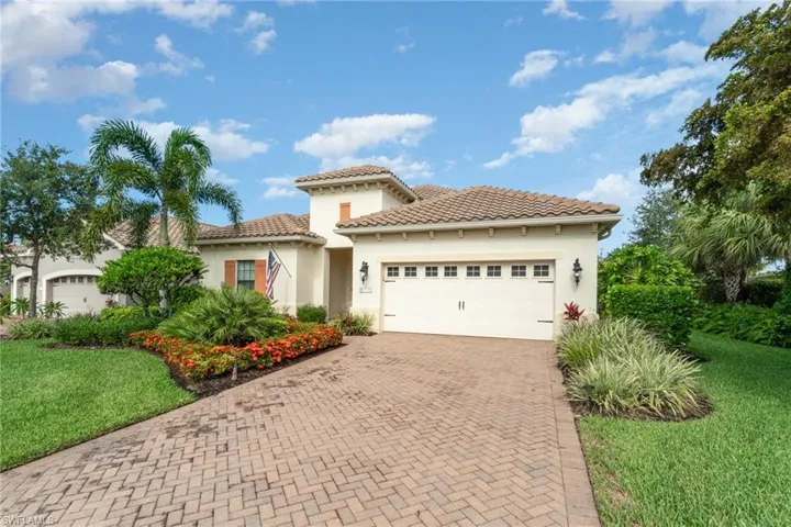 Mediterranean style house featuring a garage and a front lawn