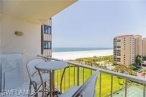 Balcony with view of water and beach