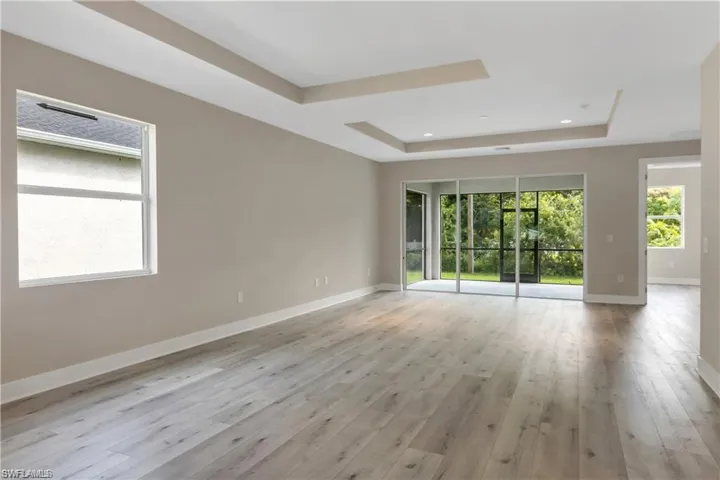 Spare room featuring light hardwood / wood-style flooring and a tray ceiling