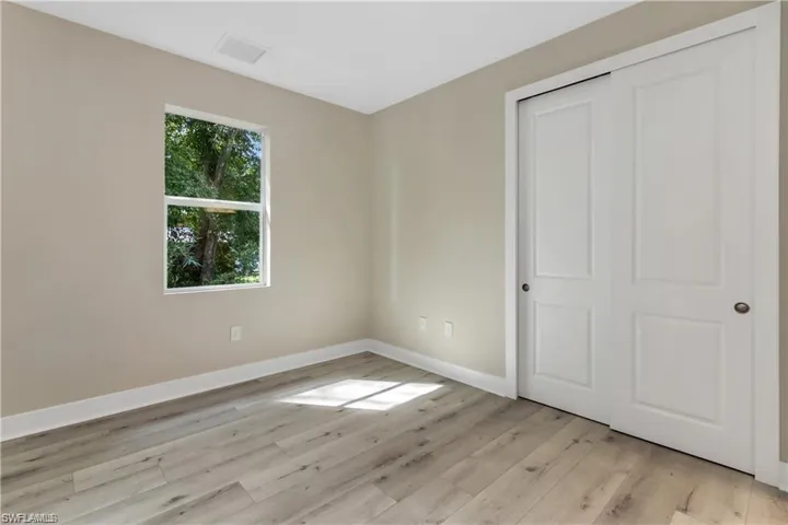 Unfurnished bedroom featuring light hardwood / wood-style floors and a closet