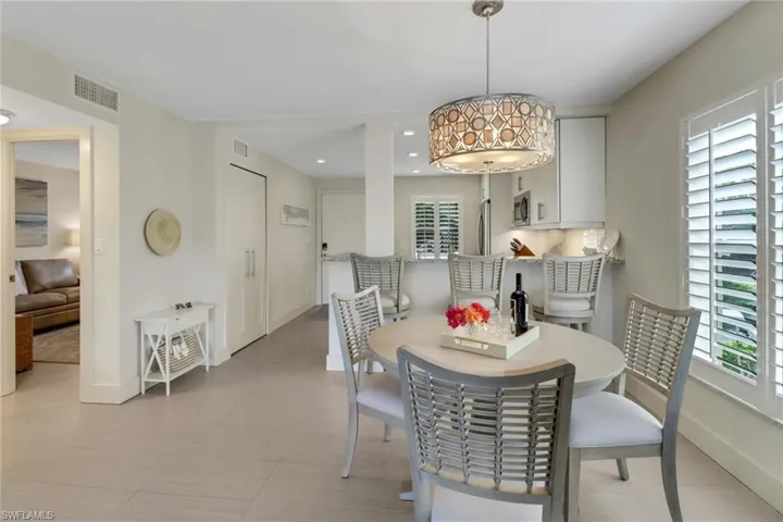 Dining area with recessed lighting and light tile patterned floors