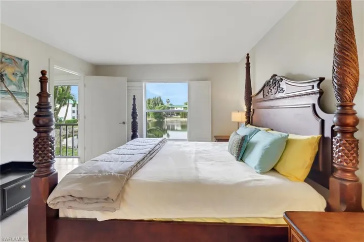 Primary bedroom has a peaceful lake view, walk in closet and en suite bathroom.