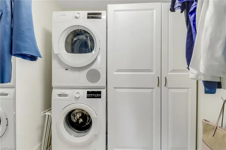 Laundry area featuring estacked washer and dryer inside the walk in closet