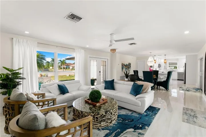 Living room with recessed lighting, french doors, and ceiling fan