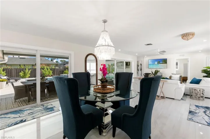 Dining space with a chandelier, recessed lighting, and ceiling fan