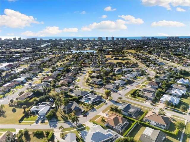 Aerial view of property and surrounding area with skyline and nearby suburban area