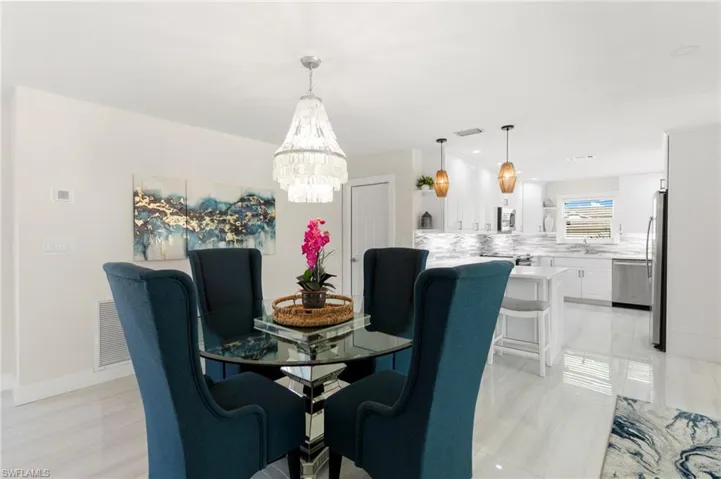 Dining room with a chandelier and recessed lighting