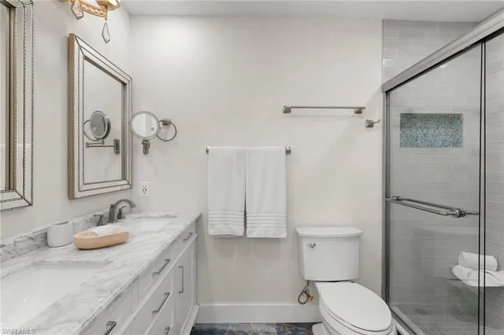 Bathroom with double vanity and a shower stall