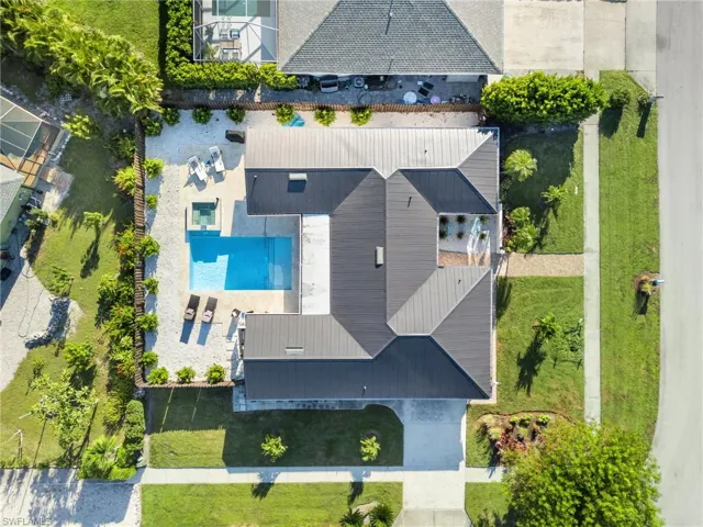 Aerial view of property and surrounding area with a pool area