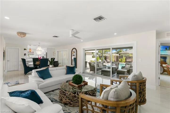 Living room with ceiling fan and recessed lighting