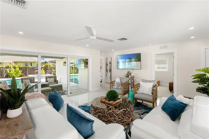 Living area featuring healthy amount of natural light, ceiling fan, and recessed lighting