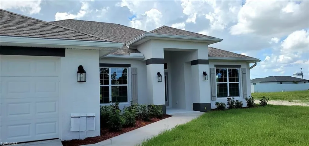 View of front of home featuring a garage and a front yard
