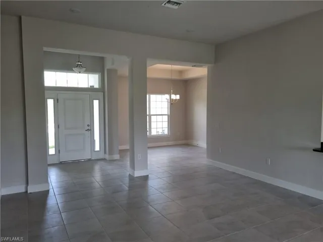 Foyer entrance featuring a chandelier and tile patterned floors
