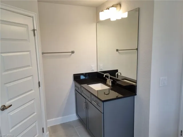 Bathroom with vanity and tile patterned flooring