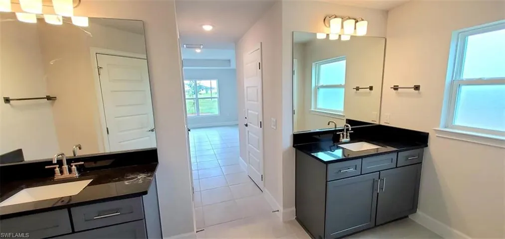Primary Bathroom featuring vanity and tile patterned flooring