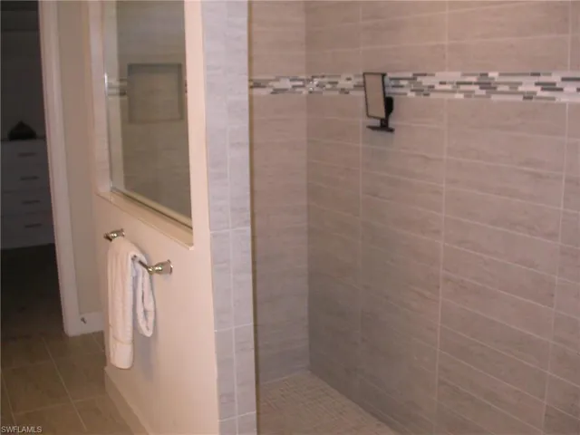 Shower featuring tile patterned flooring and a tile shower