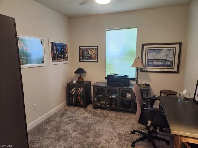 Carpeted office featuring baseboards