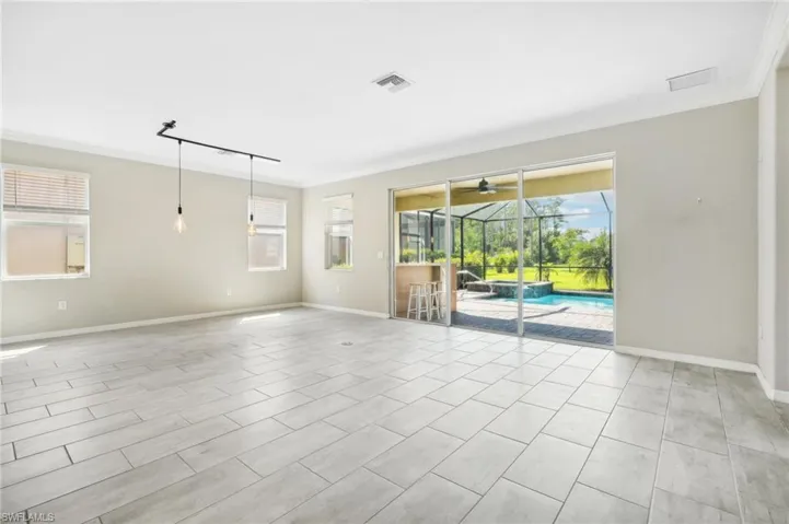 Tiled great room with plenty of natural light, and crown molding.
