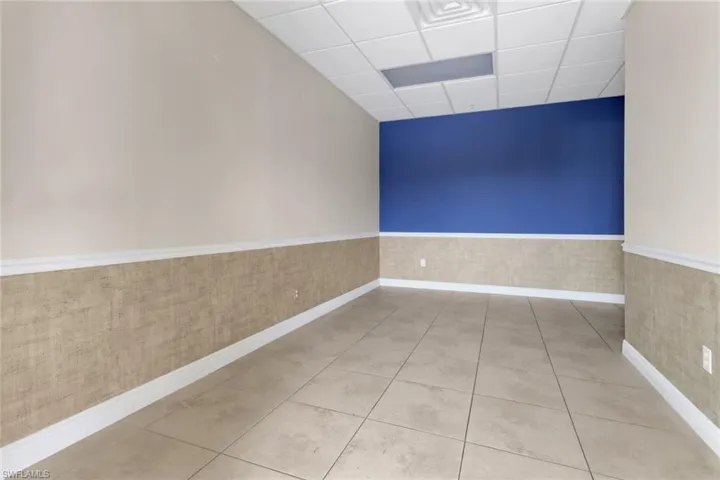Tiled spare room with a paneled ceiling