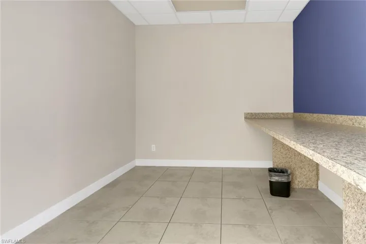 Clothes washing area featuring tile patterned flooring