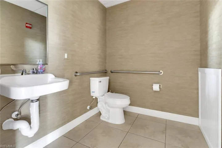 Bathroom featuring tile patterned flooring and toilet