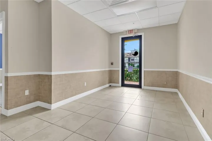 Tiled spare room featuring a paneled ceiling