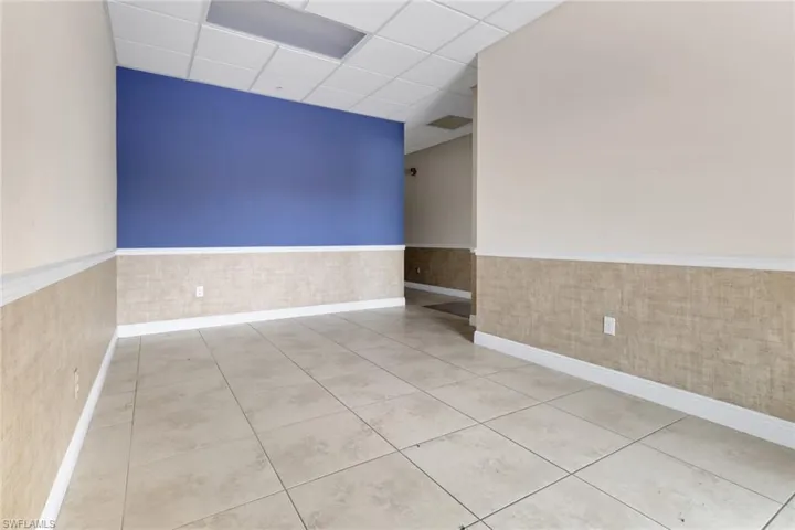 Carpeted spare room with a paneled ceiling