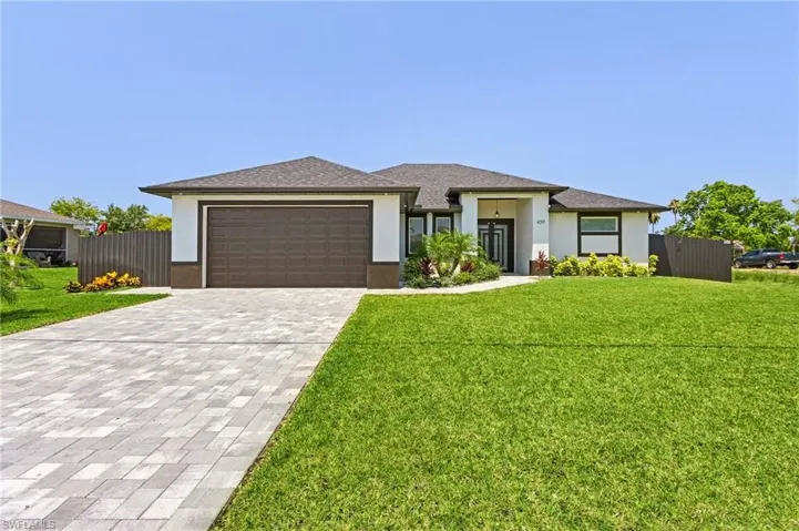 Prairie-style house featuring a front lawn and a garage