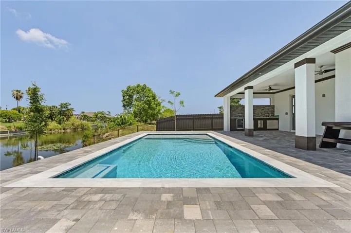 View of swimming pool with a patio area and ceiling fan