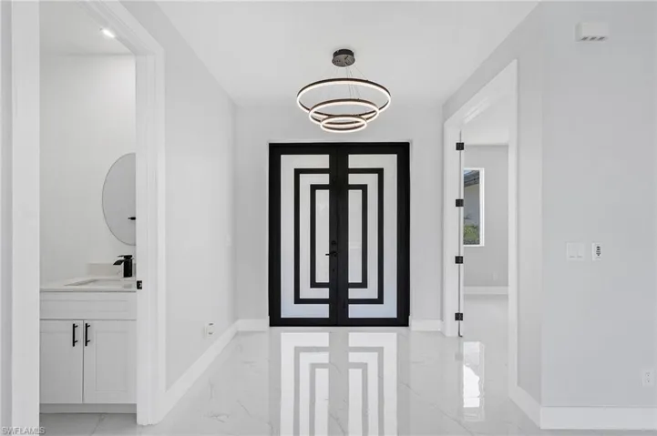 Foyer featuring sink and light tile flooring