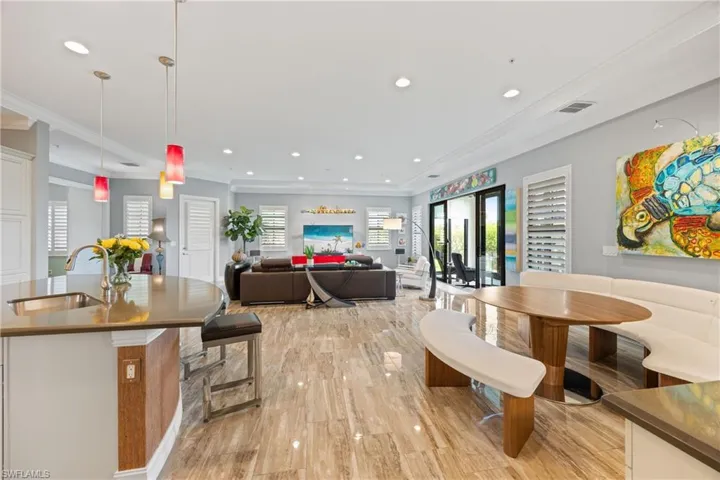 Dining space featuring ornamental molding, large format Porcelain Tile flooring, and recessed lighting