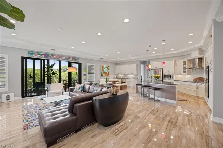 Living area featuring crown molding and recessed lighting