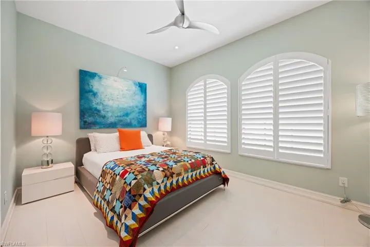 Bedroom featuring baseboards, Maple wood flooring and a ceiling fan