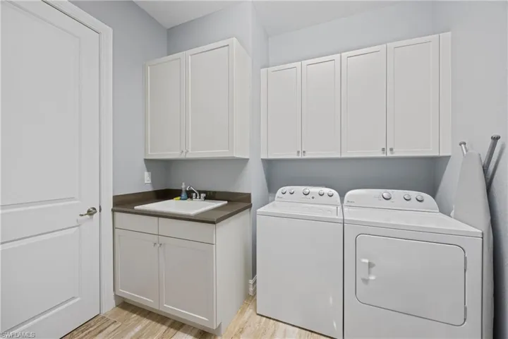 Laundry room with washer and clothes dryer, cabinet space