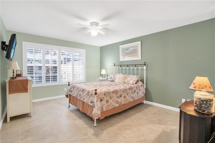 Over sized master bedroom with walk in closet plantation shutters & water views