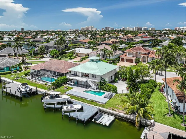 Aerial view of residential area featuring a nearby body of water