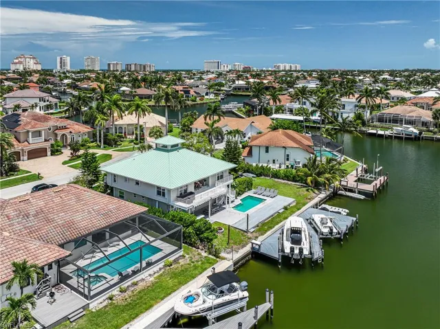 Aerial view of residential area featuring a nearby body of water