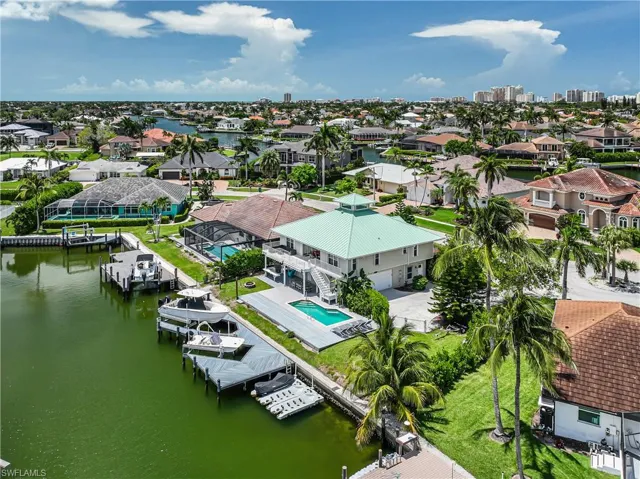 Aerial perspective of suburban area featuring a large body of water