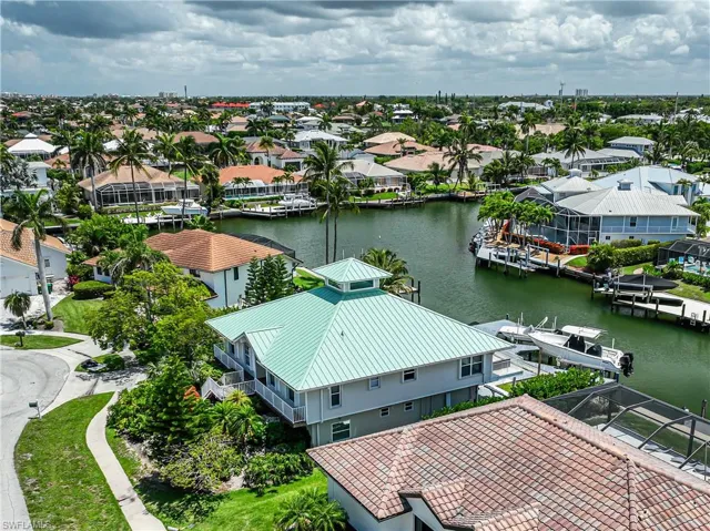 Aerial perspective of suburban area featuring a nearby body of water