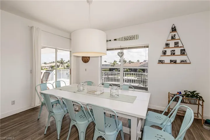 Dining space featuring dark wood-style flooring
