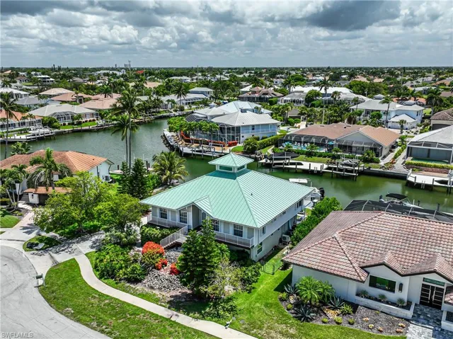 Aerial view of residential area featuring a large body of water